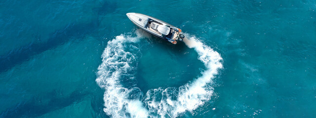 Aerial drone top down ultra wide photo with copy space of inflatable power rib boat making extreme...