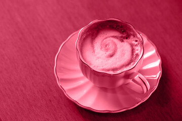 coffee in a pink cup, toned in pink