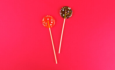 Two round lollipops on pink background