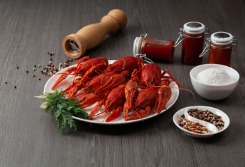 Lots of boiled crawfish on a plate on the wooden table