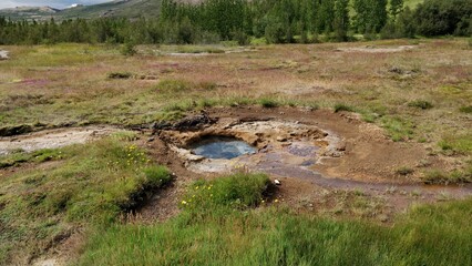 Small pool of crystal clear hot water near the Stokkur Geyser in Iceland
