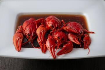 Large boiled crawfish in sauce on a plate