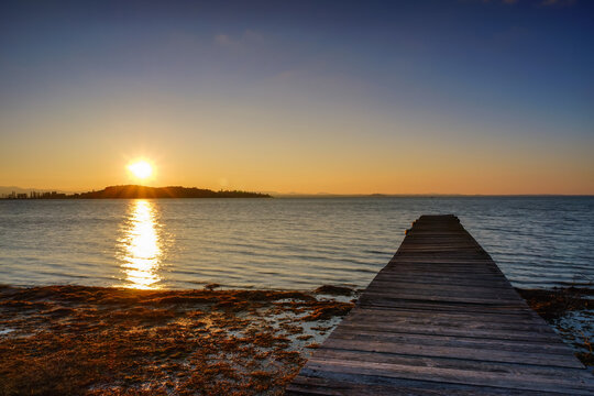 Wooden warf over Isola Polvese at the sunset, Trasimeno Lake, Perugia, Umbria, Italy