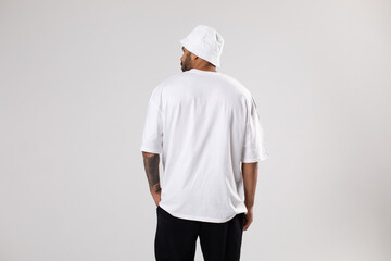 Man in a white t-shirt and panama. Mock-up. Back view.