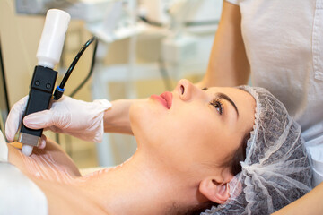 Procedure of ultrasonic cleaning of neck. Ultrasonic scraber.