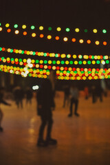 People on the ice rink, blurred, multicoloured, evening lights