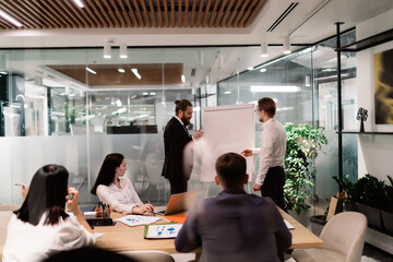 Fototapeta na wymiar Group of businesspeople holding briefing in meeting room