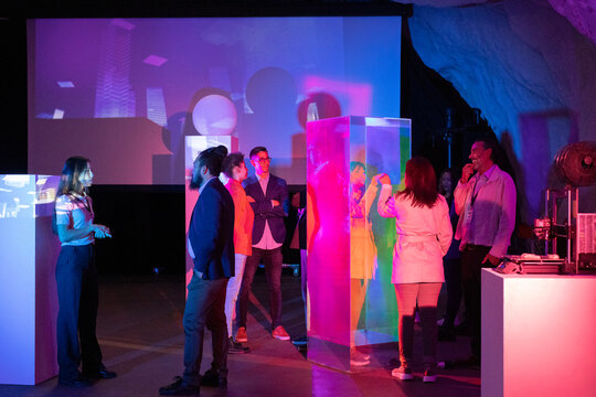 Business colleagues discussing during meeting at illuminated workshop