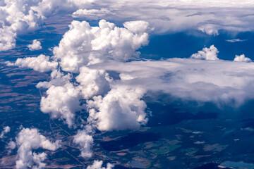 Aerial view of large puffy clouds outside of my airplane window