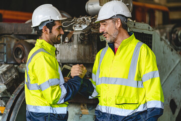 Two senior male engineers and workers wearing safety vests and jacket along with hardhat or helmet...