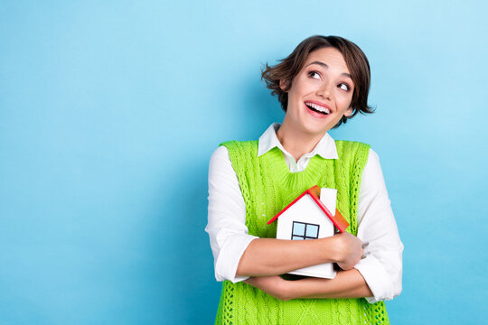 Photo of positive lovely lady wear stylish clothes look empty space announcement offer buy new house isolated on cyan color background