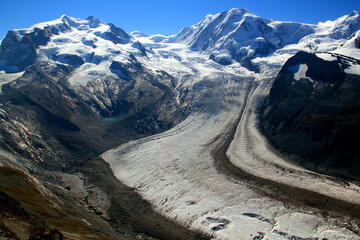 View of the snow-white Matterhorn glacier with a small lake from Mount Gornergrat near Zermatt in...