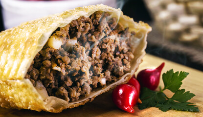 Fried dough stuffed with ground meat, called pastel, typical Brazilian food, typical brazilian salt, served in bakeries, bars and restaurants © RHJ