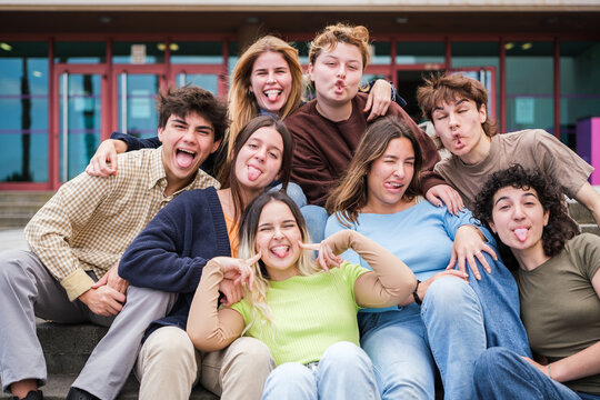 Group of students together resting from hours of study and with funny faces having a good time. Concept: fun, studies, education