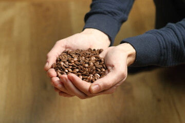coffee beans held in hands