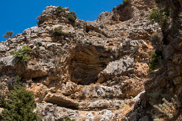 Cave on steep slope of a mountains at Rhodes Island