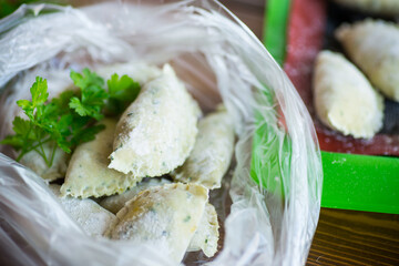 Raw green dough dumplings with parsley, dill.
