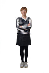 front view full length portrait of a woman in skirt, striped sweater and sneakers with arms crossed and serious expression on white background © Curto