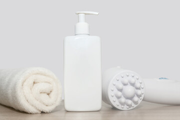 White massager towel and dispenser. On a wooden surface. Therapeutic massage.