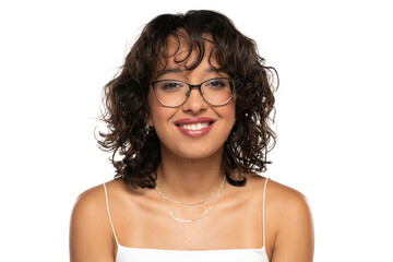Young dark skinned smiling woman with makeup, glasses  and wavy hair posing on a white studio...