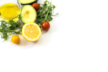 Ingredients of healthy food. Micro green pea sprouts, olive oil, cucumber, tomato, avocado, lemon. Ketogenic low carbs diet concept.