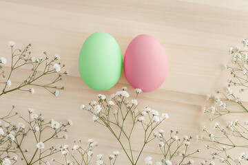 two Easter eggs. Easter card. Easter eggs on a background of white flowers gypsophila