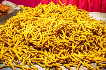Sev and Til (Sesame seeds) revdi, rewri, rewadi, revadi, revri. A bunch of popular Indian sweets at the night market near the temple. Sweet Indian background