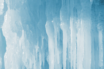 Icicles in ice cave in winter. Abstract winter nature background..