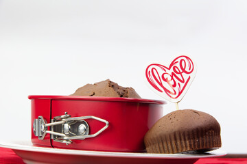 Chocolate muffin with heart and love on red hearts
