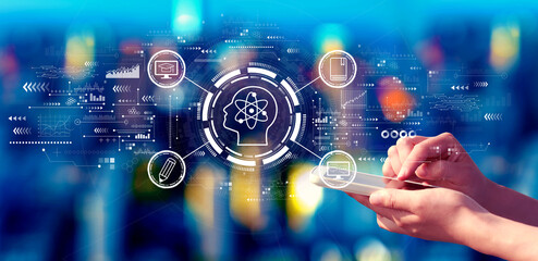 Online education concept with person using a smartphone in a city at night