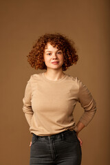 Portrait of a cute ginger girl with curly hair.