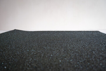 A Black Sandpaper in front of the White Wall