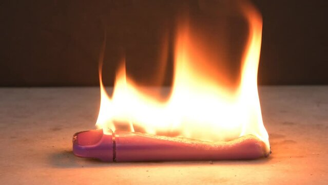 An electronic cigarette burns with fire and melts 