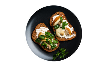 Black plate with porcini mushroom sandwiches on isolated png background top view flat lay