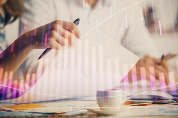 Double exposure of forex graph drawing over people taking notes background. Concept of financial analysis