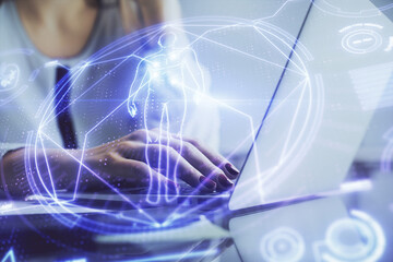 Double exposure of woman hands typing on computer and general theme hologram drawing. Education...