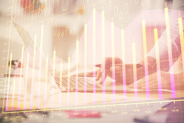 Double exposure of woman hands typing on computer and forex chart hologram drawing. Stock market...