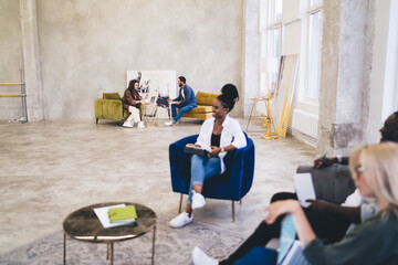 Multiethnic designers working in loft style office