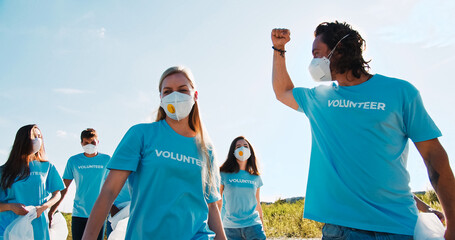 A leader of conservationists cheering and boosting team spirit. Volunteering