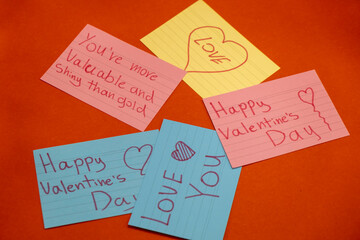 Five Colorful and Diffrent Signs with Valentine's Day Words Written on them (Love, Happy valentine's Day) Isolated on Red Background and Roses on the sides