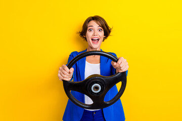 Photo of shocked lady buy new car impressed fast speed control steering wheel isolated on vibrant color background
