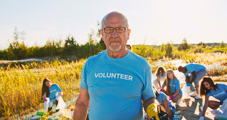 A voluntary organisation conserving environment to save our planet. A senior eco activist holding a...