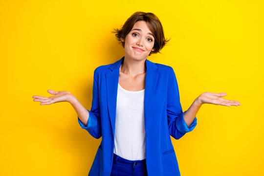 Photo of young uncertain attractive business woman shrug shoulders no idea sorry forgot salary payment employee isolated on yellow color background