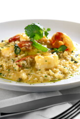 shrimp risotto served on plate