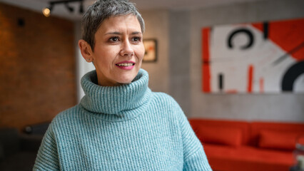One senior caucasian woman stand with cup of coffee at home indoor