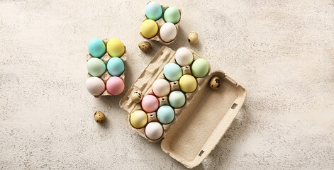 Holders with different Easter eggs on light background