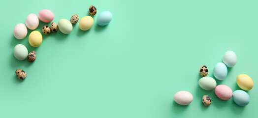 Painted Easter eggs on turquoise background with space for text