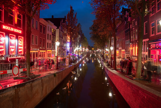 Amsterdam, Netherlands- 09-18-2022- A look down the canal at night in Amsterdam's Red Light district. 