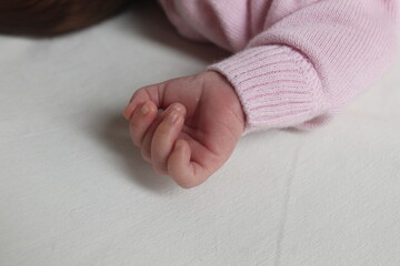 Palm handle a newborn baby on a white light background with space for text copyspace. Child in the family care for newborns