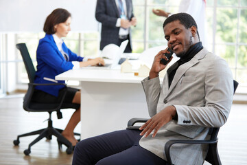 African businessman talking on smartphone for work in the office